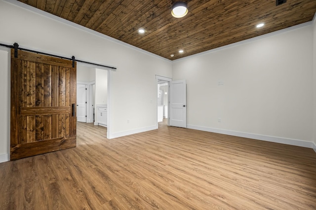 unfurnished bedroom featuring recessed lighting, a barn door, wooden ceiling, wood finished floors, and baseboards