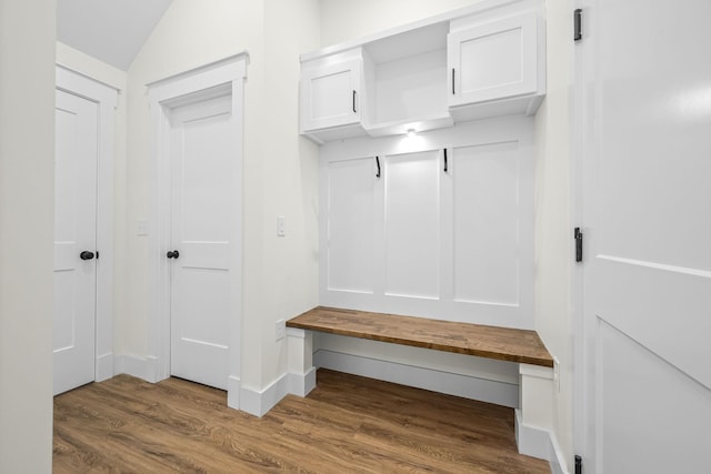 mudroom with lofted ceiling, baseboards, and wood finished floors