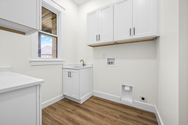 laundry room featuring electric dryer hookup, dark wood-type flooring, washer hookup, a sink, and cabinet space
