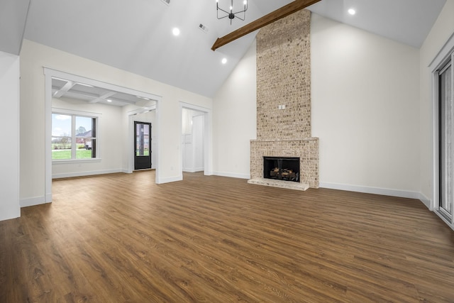 unfurnished living room with dark wood-type flooring, beamed ceiling, and baseboards