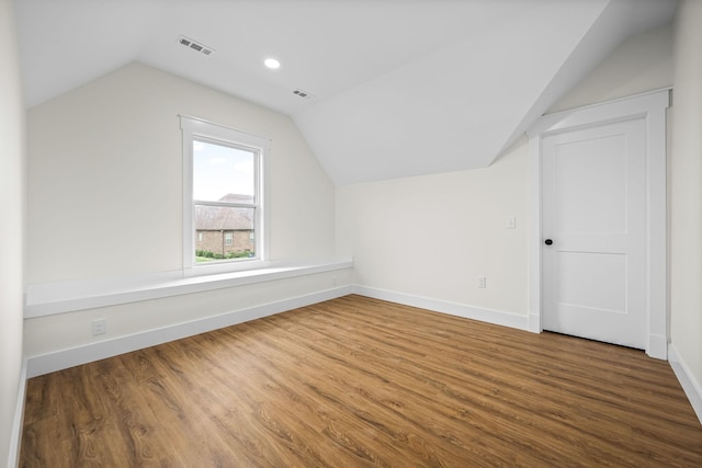 bonus room with visible vents, baseboards, wood finished floors, and lofted ceiling
