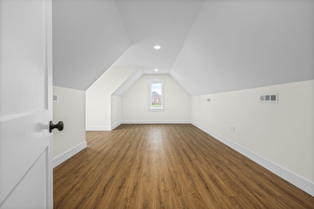 bonus room with baseboards, vaulted ceiling, recessed lighting, visible vents, and wood finished floors
