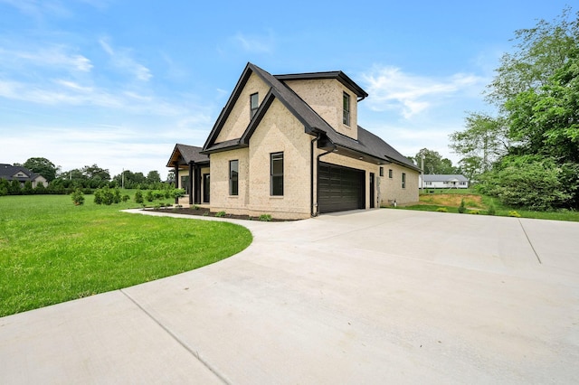 102 Victoria Ct N, Tullahoma, TN 37388 - view of property exterior featuring driveway, a lawn, a garage, and brick siding