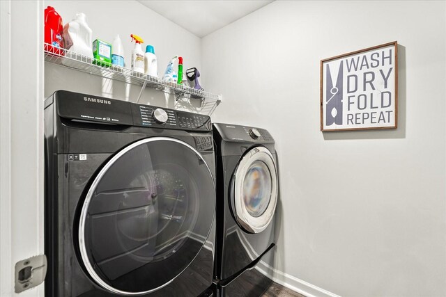 1428 Marigold Dr, Spring Hill, TN 37174 - clothes washing area with washing machine and clothes dryer, wood finished floors, laundry area, and baseboards