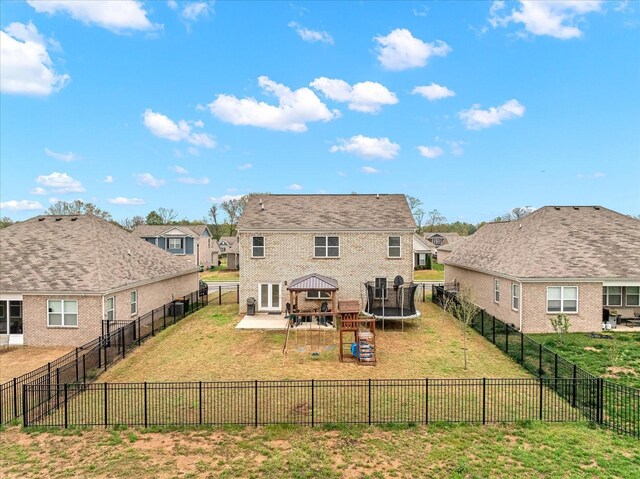 1428 Marigold Dr, Spring Hill, TN 37174 - rear view of property featuring a fenced backyard, a lawn, a patio, a playground, and a trampoline
