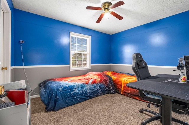 carpeted bedroom featuring a textured ceiling and ceiling fan