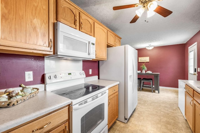 kitchen featuring white appliances, light countertops, a textured ceiling, and ceiling fan