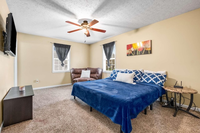 bedroom featuring a textured ceiling, carpet flooring, baseboards, and a ceiling fan