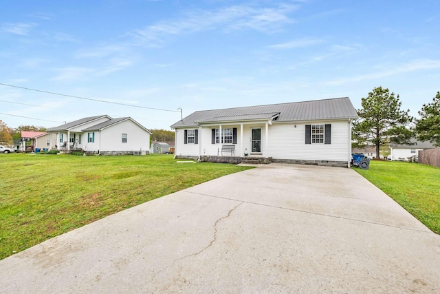 single story home featuring crawl space, metal roof, a front yard, and driveway