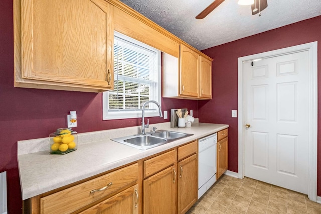 kitchen with white dishwasher, a sink, light countertops, ceiling fan, and a textured ceiling