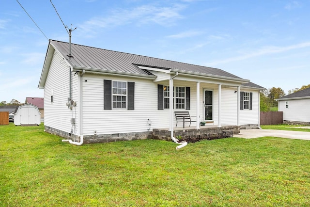 single story home featuring crawl space, a porch, metal roof, fence, and a front lawn