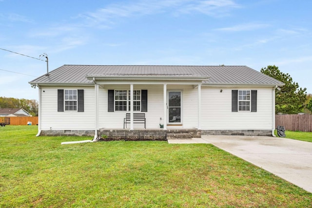 view of front of house with a front lawn, fence, metal roof, and crawl space