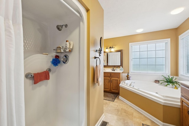 full bathroom with a garden tub, a stall shower, and vanity