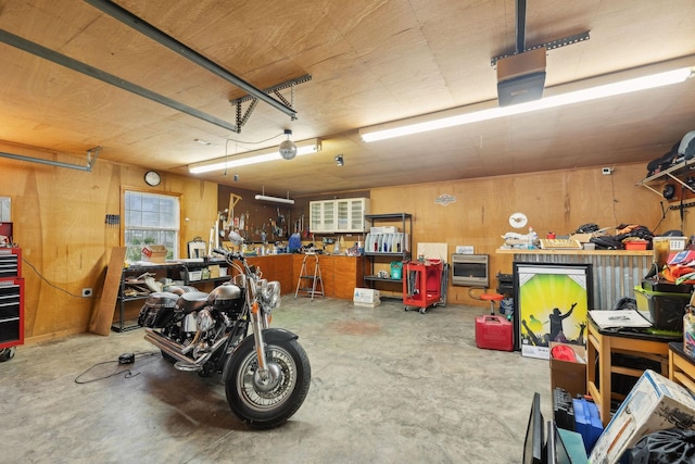 garage with wood walls and a workshop area
