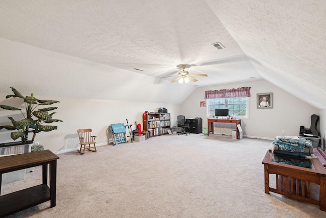 recreation room featuring a ceiling fan, a textured ceiling, vaulted ceiling, and carpet