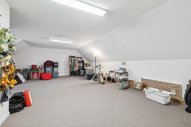 bonus room with carpet, vaulted ceiling, and a textured ceiling
