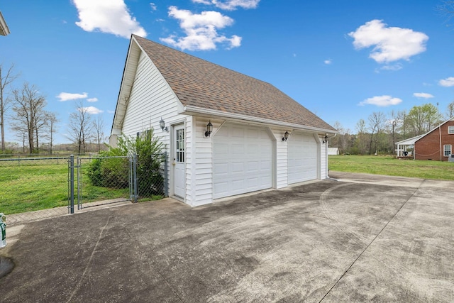 detached garage featuring fence