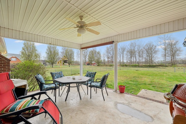 view of patio / terrace featuring a grill, ceiling fan, fence, and outdoor dining area