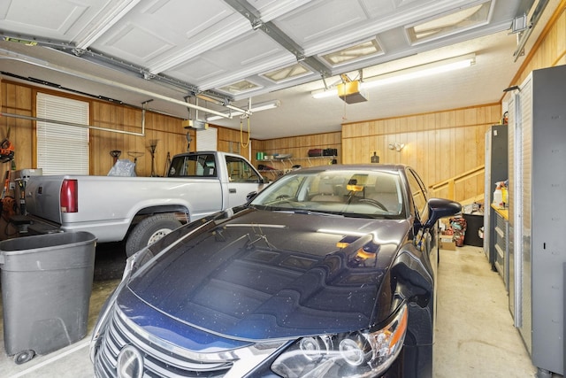 garage featuring wood walls and a garage door opener