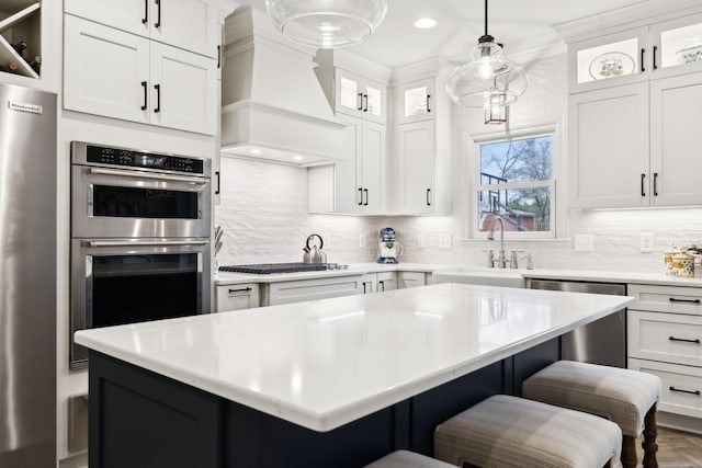 2009 Cedarmont Dr, Franklin, TN 37067 - kitchen featuring appliances with stainless steel finishes, custom range hood, light countertops, and backsplash