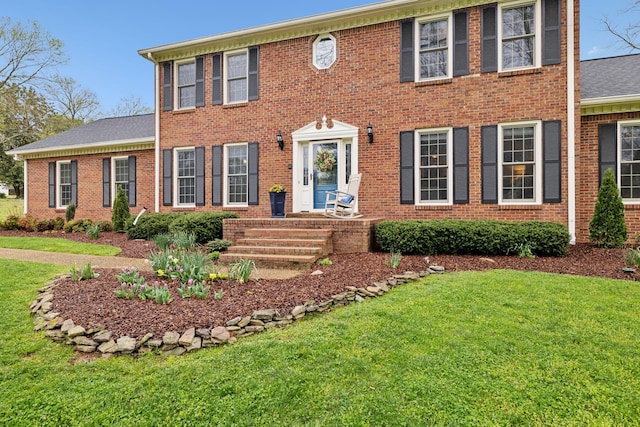 2009 Cedarmont Dr, Franklin, TN 37067 - colonial home featuring a shingled roof, brick siding, and a front lawn