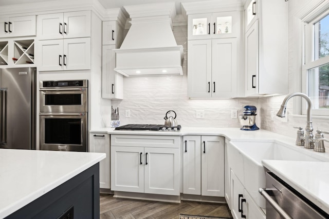 2009 Cedarmont Dr, Franklin, TN 37067 - kitchen with premium range hood, light countertops, backsplash, and appliances with stainless steel finishes