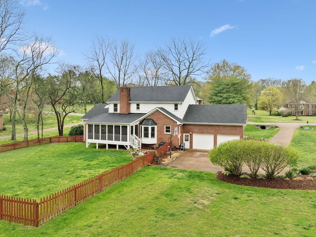 2009 Cedarmont Dr, Franklin, TN 37067 - rear view of property with a sunroom, a lawn, a garage, a chimney, and driveway