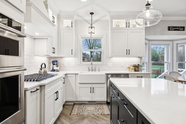 2009 Cedarmont Dr, Franklin, TN 37067 - kitchen featuring crown molding, white cabinets, appliances with stainless steel finishes, and a sink