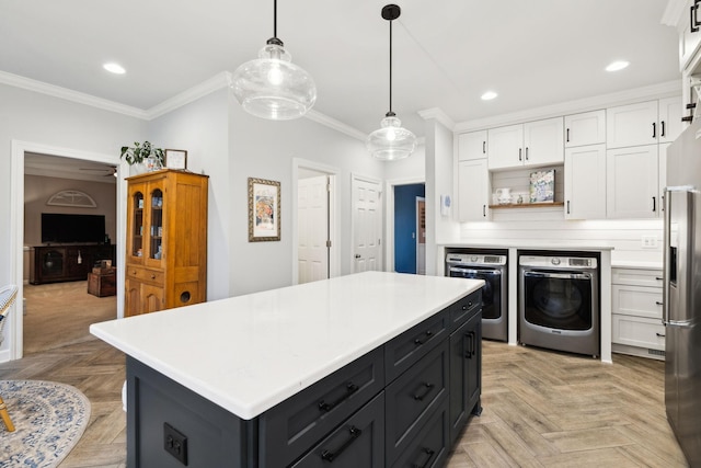 2009 Cedarmont Dr, Franklin, TN 37067 - kitchen featuring separate washer and dryer, white cabinetry, ornamental molding, wall oven, and dark cabinetry