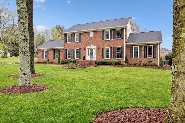 2009 Cedarmont Dr, Franklin, TN 37067 - colonial home with central air condition unit, a shingled roof, a front yard, and brick siding
