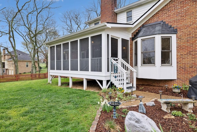 2009 Cedarmont Dr, Franklin, TN 37067 - rear view of house featuring a yard, fence, a sunroom, and a chimney