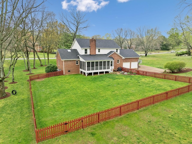 2009 Cedarmont Dr, Franklin, TN 37067 - back of property with a sunroom, a yard, a fenced backyard, brick siding, and driveway