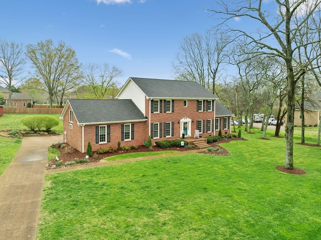 2009 Cedarmont Dr, Franklin, TN 37067 - colonial inspired home with concrete driveway, a front yard, and brick siding