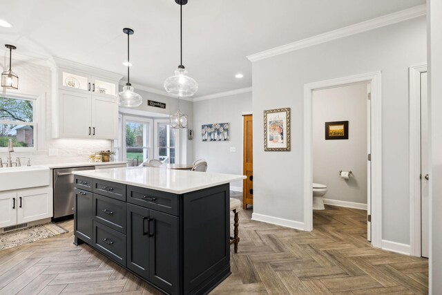 2009 Cedarmont Dr, Franklin, TN 37067 - kitchen featuring stainless steel dishwasher, white cabinets, light countertops, and ornamental molding
