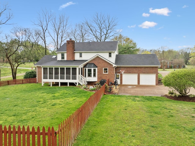 2009 Cedarmont Dr, Franklin, TN 37067 - back of property featuring a sunroom, fence private yard, an attached garage, a chimney, and driveway