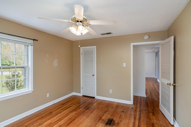 740 Kleeman Dr, Clarksville, TN 37040 - unfurnished bedroom with wood finished floors, a closet, ceiling fan, baseboards, and visible vents