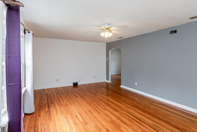 740 Kleeman Dr, Clarksville, TN 37040 - spare room featuring baseboards, a ceiling fan, wood finished floors, and arched walkways