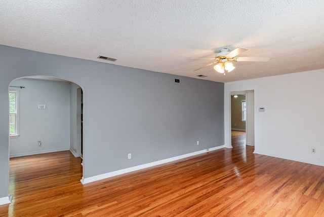 740 Kleeman Dr, Clarksville, TN 37040 - unfurnished room with arched walkways, light wood-type flooring, visible vents, and a ceiling fan