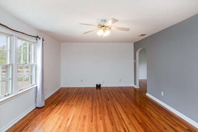 740 Kleeman Dr, Clarksville, TN 37040 - unfurnished room with a ceiling fan, wood finished floors, arched walkways, baseboards, and visible vents