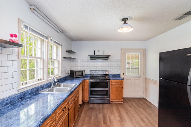 740 Kleeman Dr, Clarksville, TN 37040 - kitchen featuring range hood, open shelves, a sink, brown cabinetry, and appliances with stainless steel finishes