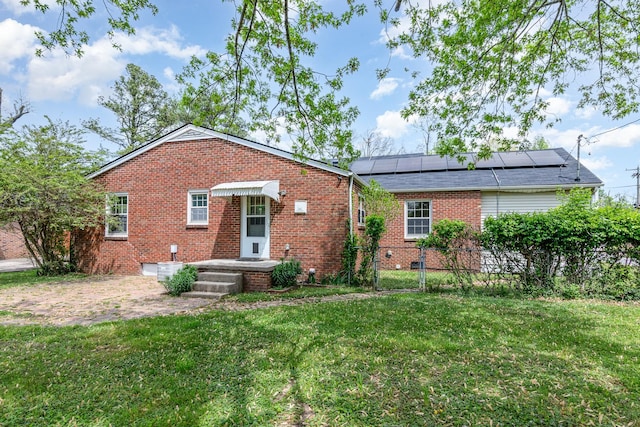 740 Kleeman Dr, Clarksville, TN 37040 - view of front of property with fence, brick siding, a front yard, and solar panels
