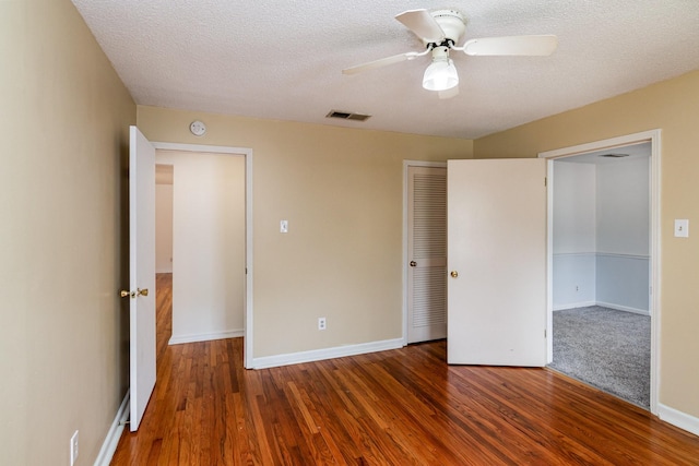 740 Kleeman Dr, Clarksville, TN 37040 - unfurnished bedroom with wood finished floors, visible vents, a closet, baseboards, and a textured ceiling