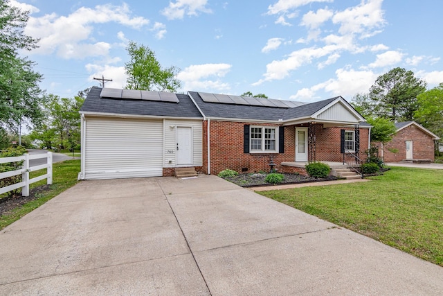740 Kleeman Dr, Clarksville, TN 37040 - ranch-style house featuring solar panels, fence, brick siding, entry steps, and a front yard