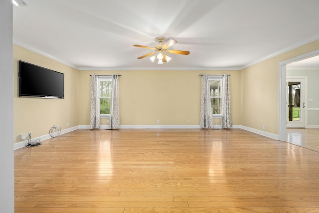unfurnished living room featuring ornamental molding, ceiling fan, light wood-style floors, and baseboards