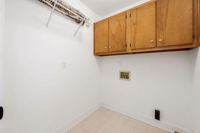washroom featuring cabinet space, baseboards, hookup for a washing machine, and light floors