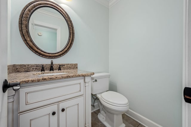 half bathroom with baseboards, toilet, crown molding, vanity, and tile patterned floors
