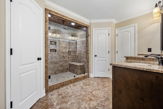 bathroom featuring a stall shower, vanity, crown molding, and baseboards