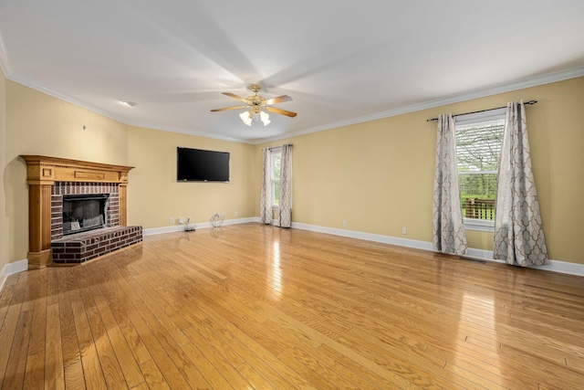 unfurnished living room featuring a wealth of natural light, ornamental molding, and ceiling fan