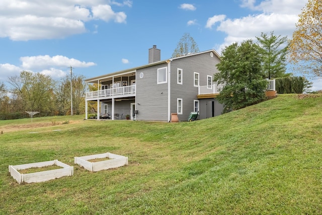 2728 Brown Hollow Rd, Columbia, TN 38401 - rear view of property with a wooden deck, a garden, a chimney, and a lawn