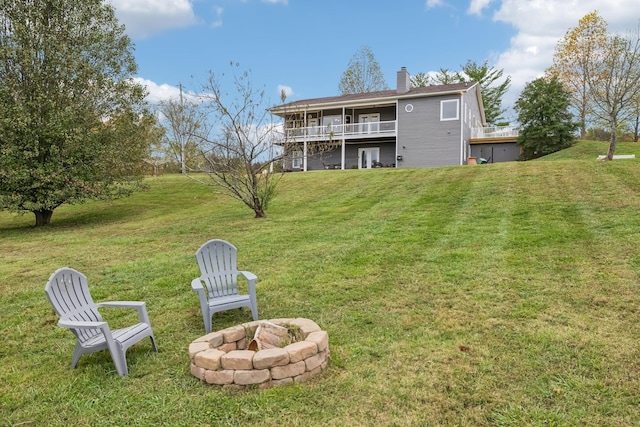 2728 Brown Hollow Rd, Columbia, TN 38401 - back of house with an outdoor fire pit, a chimney, and a lawn